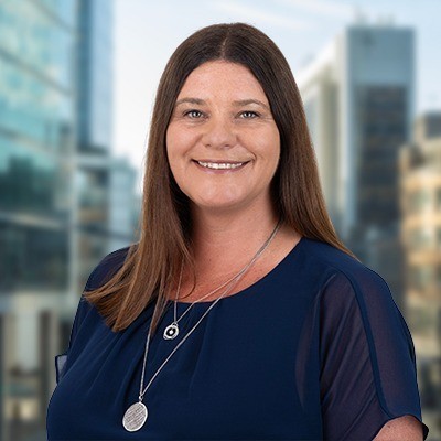 Profile portrait of a man in a white shirt against a light background