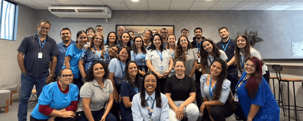 man with glasses smiling fully