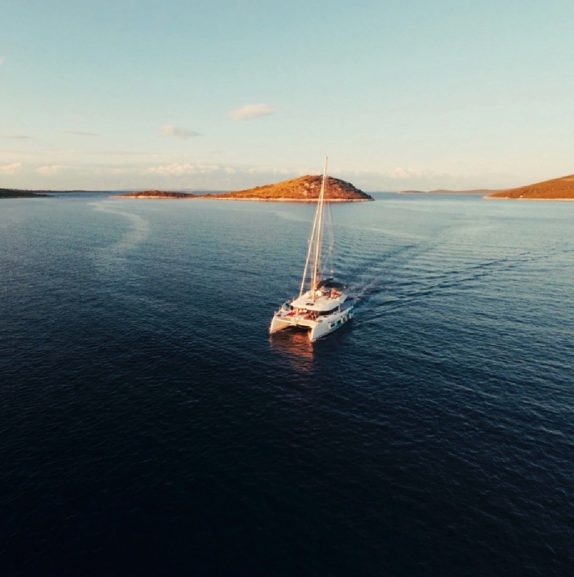 Yacht at sail during sunset.