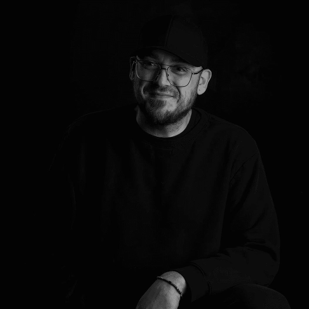 clear drinking glass with coffee on top of white table