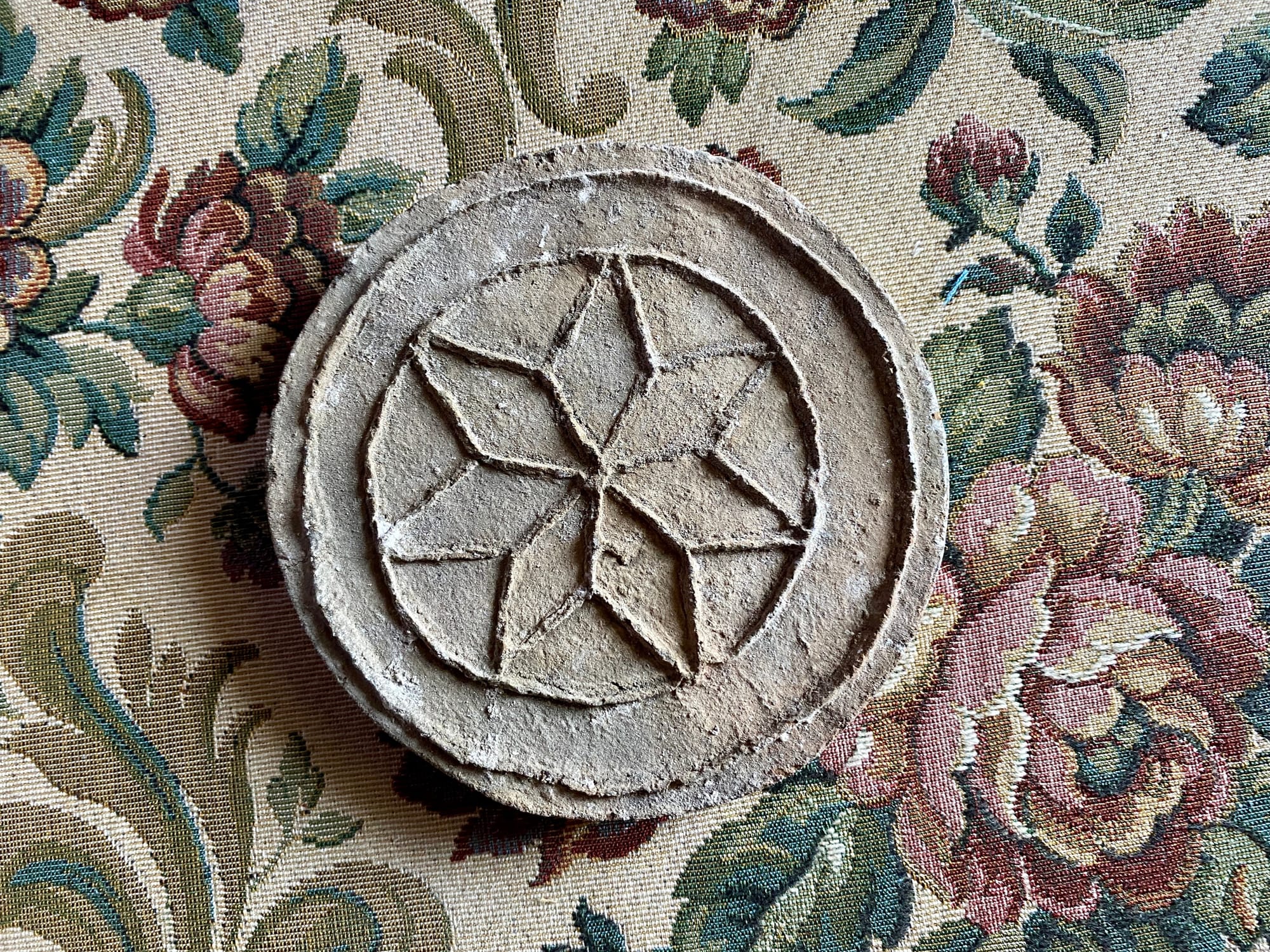 Carved stone rosette found in the house