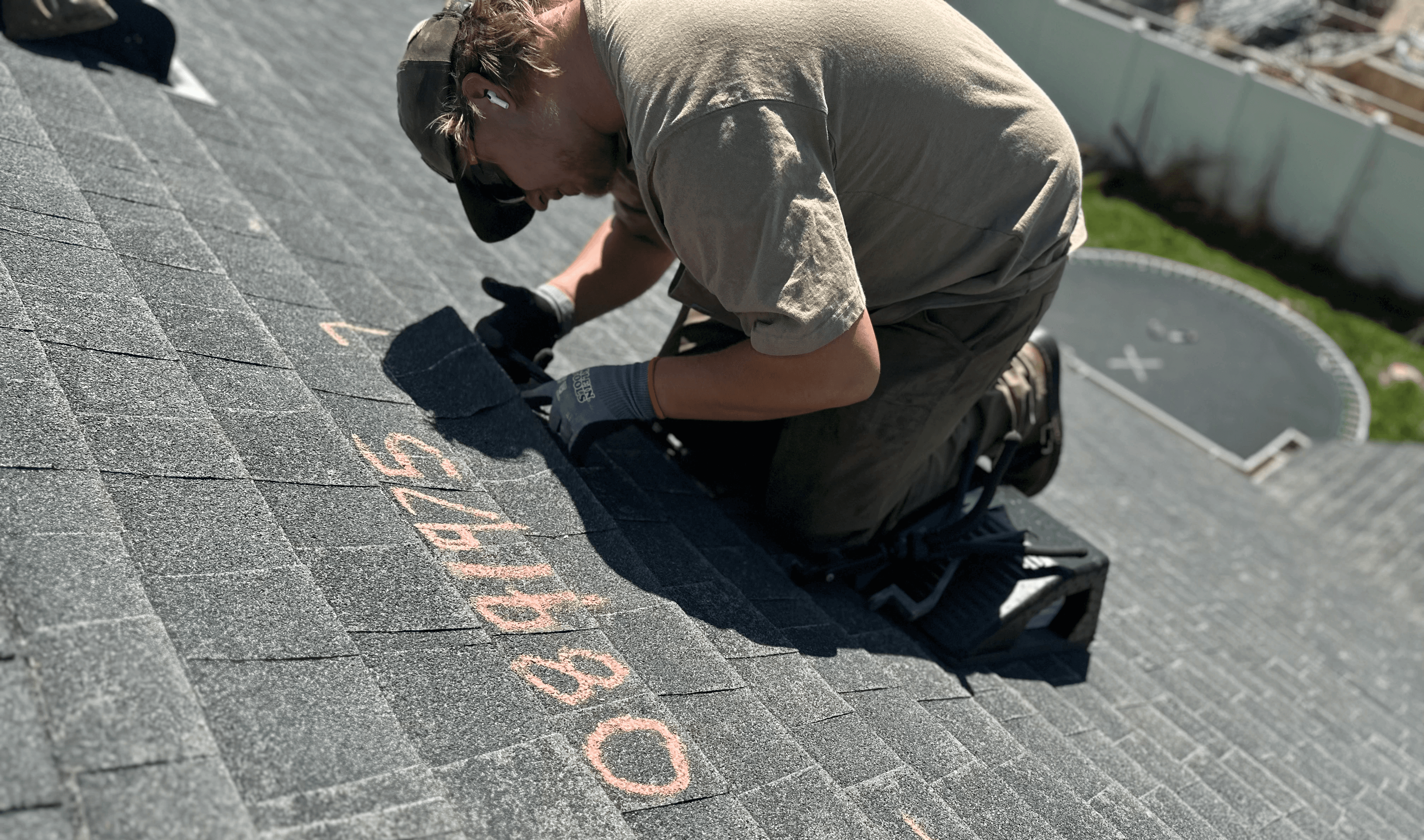 Roofing contractor standing on a home's rooftop