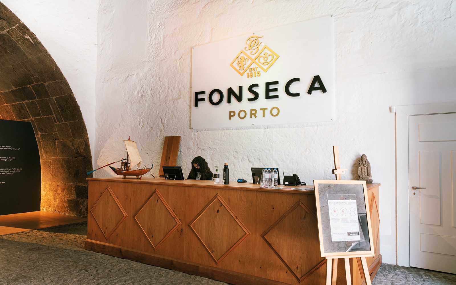Fonseca Porto borospince bejárata, recepciós pulttal és útbaigazító táblákkal.