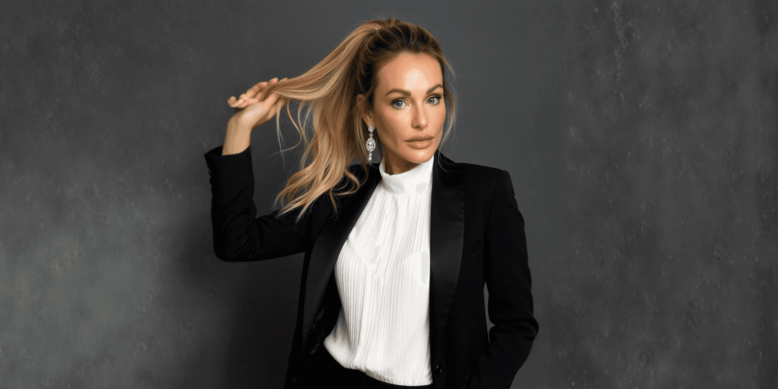 "Master Injector Natacha Christeler posing confidently in professional attire, embodying precision and artistry in aesthetic medicine."