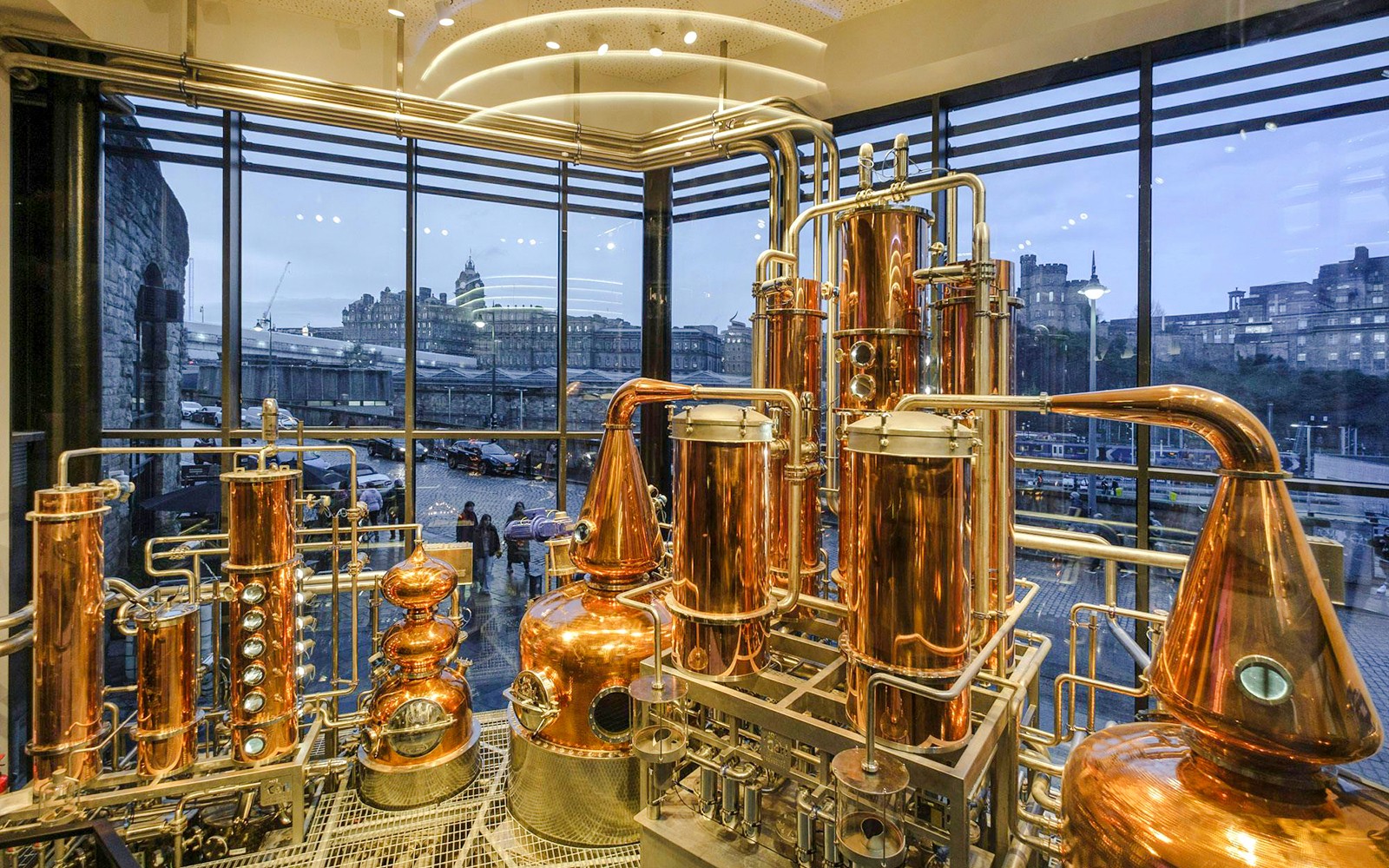 Edinburgh gin distillery tour showcasing copper stills and gin production process.