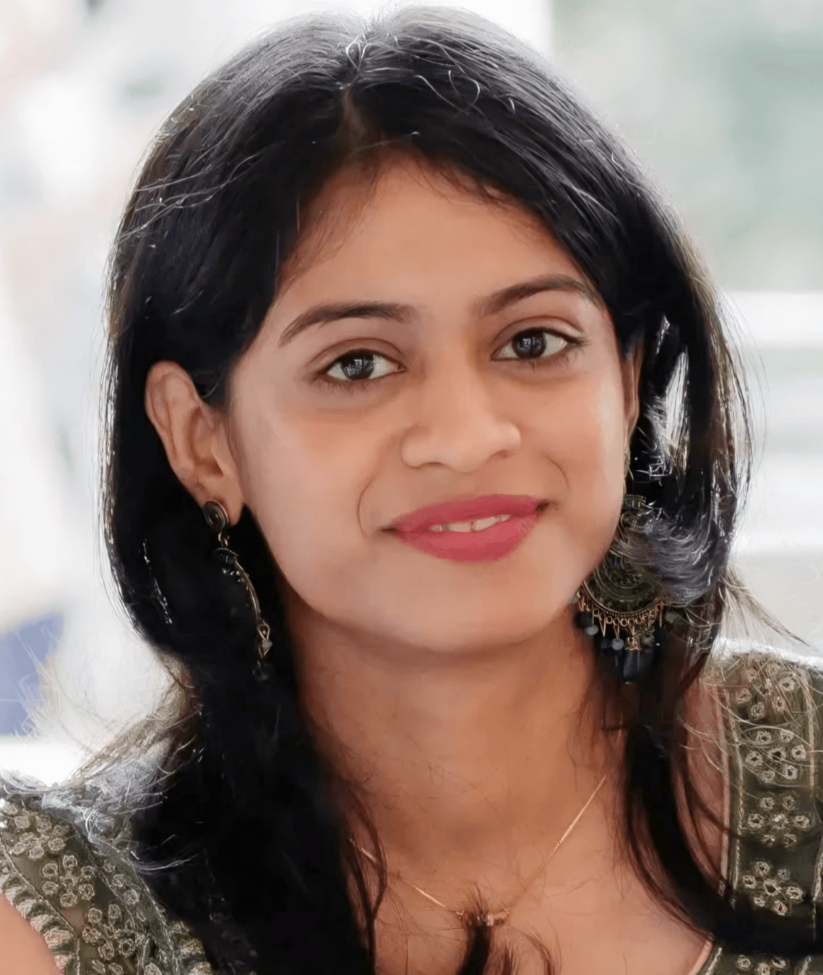 a man with a goatee smiles at the camera