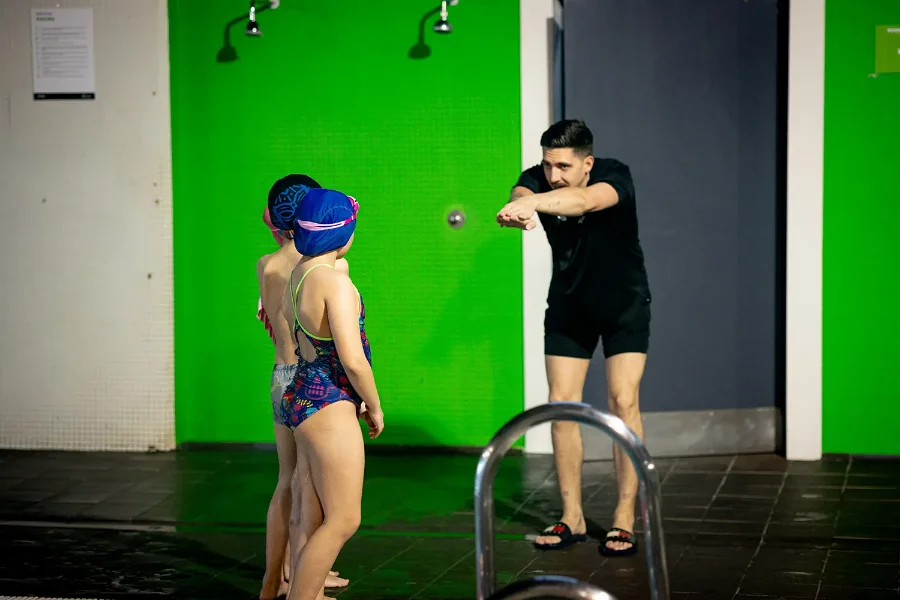 un monitor enseña natación a niños