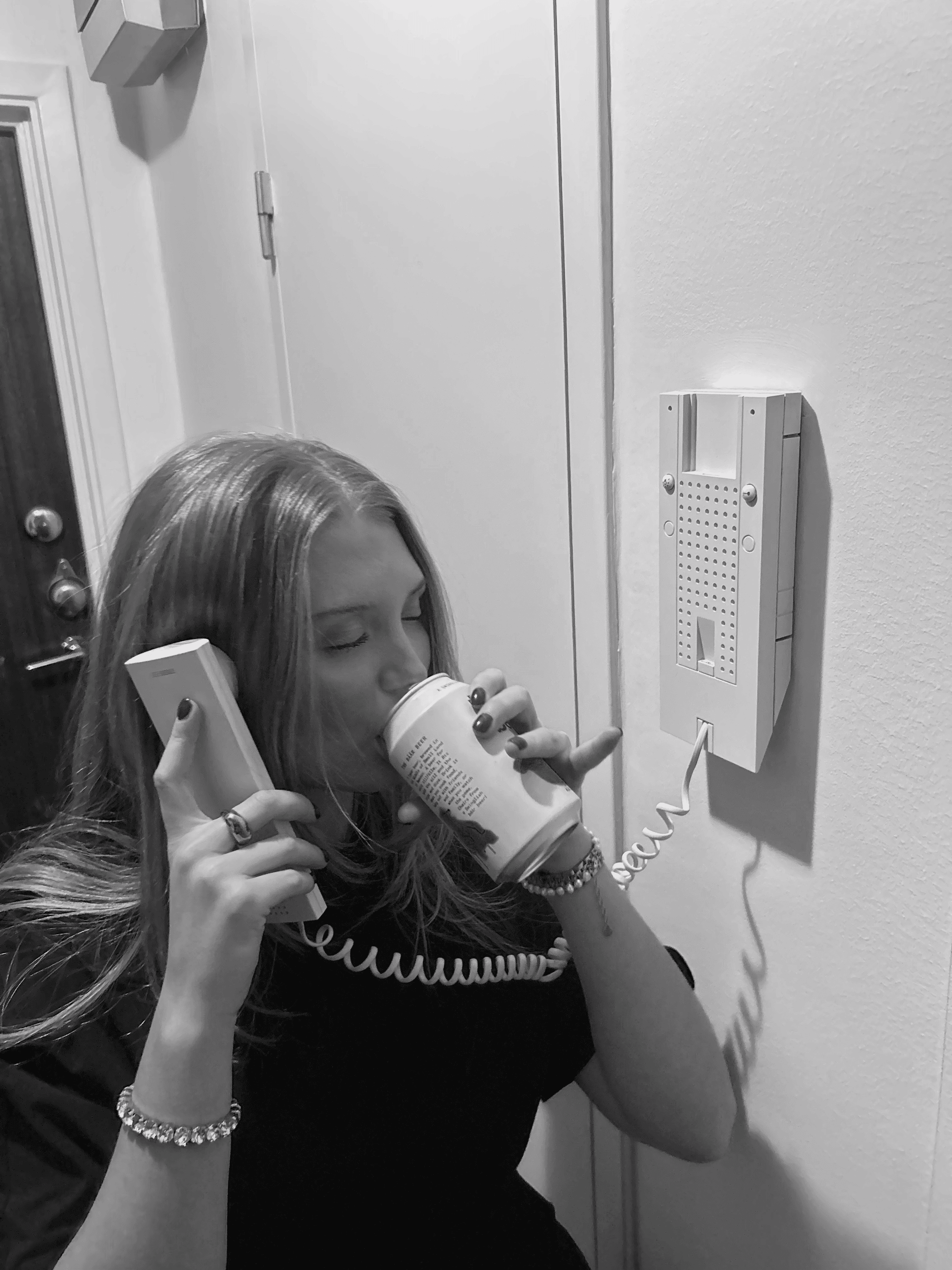 Close-up of a yellow tennis ball sitting on a green court, positioned near the white center line.