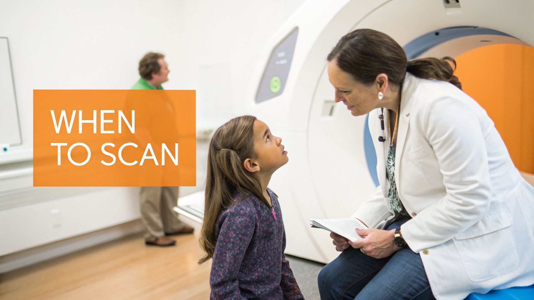 A doctor talks to a young girl in front of a medical scanner, explaining the procedure.