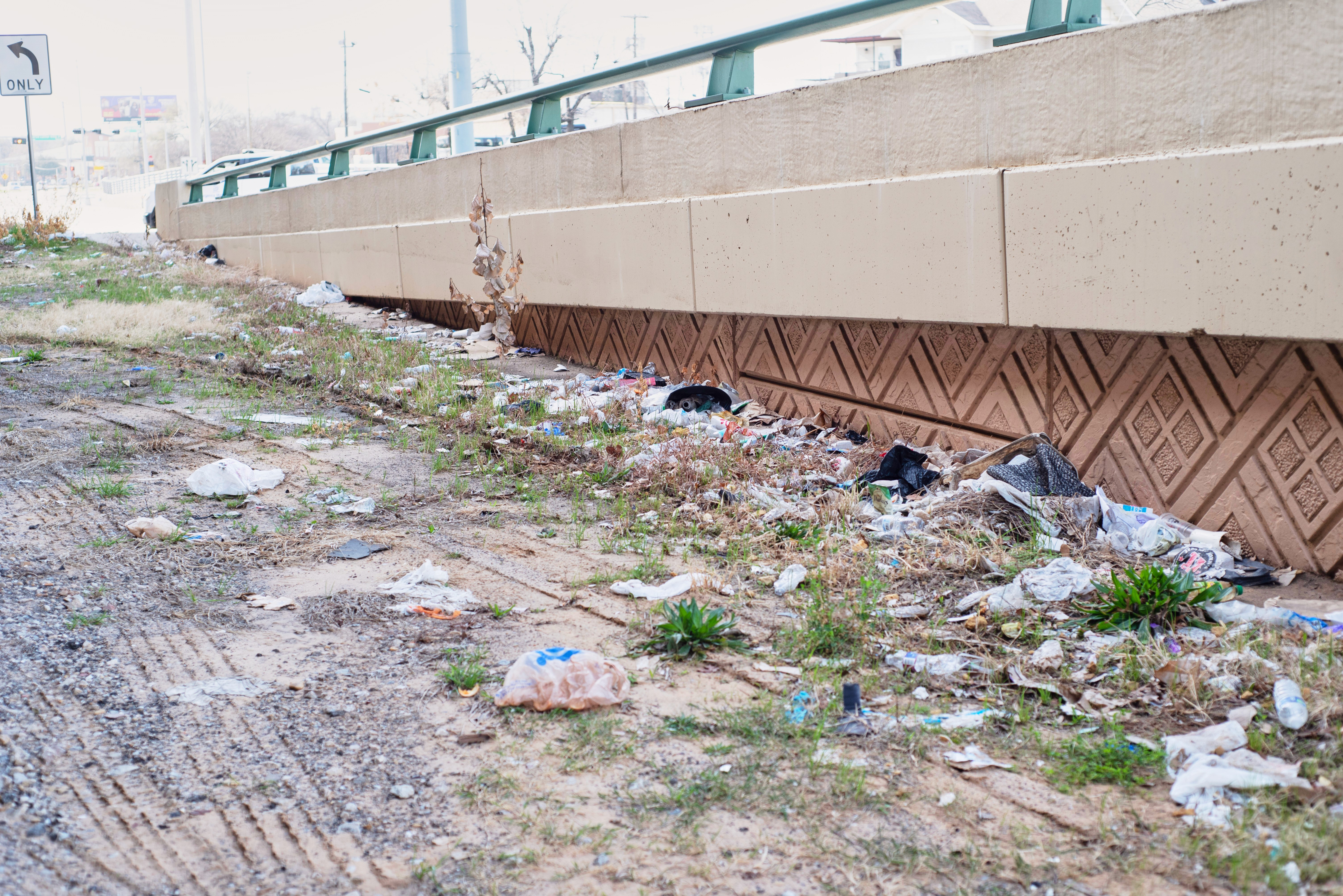 Street view with a "For Sale" sign on the corner of Crimson and Marsheller street next to a wooden pole.