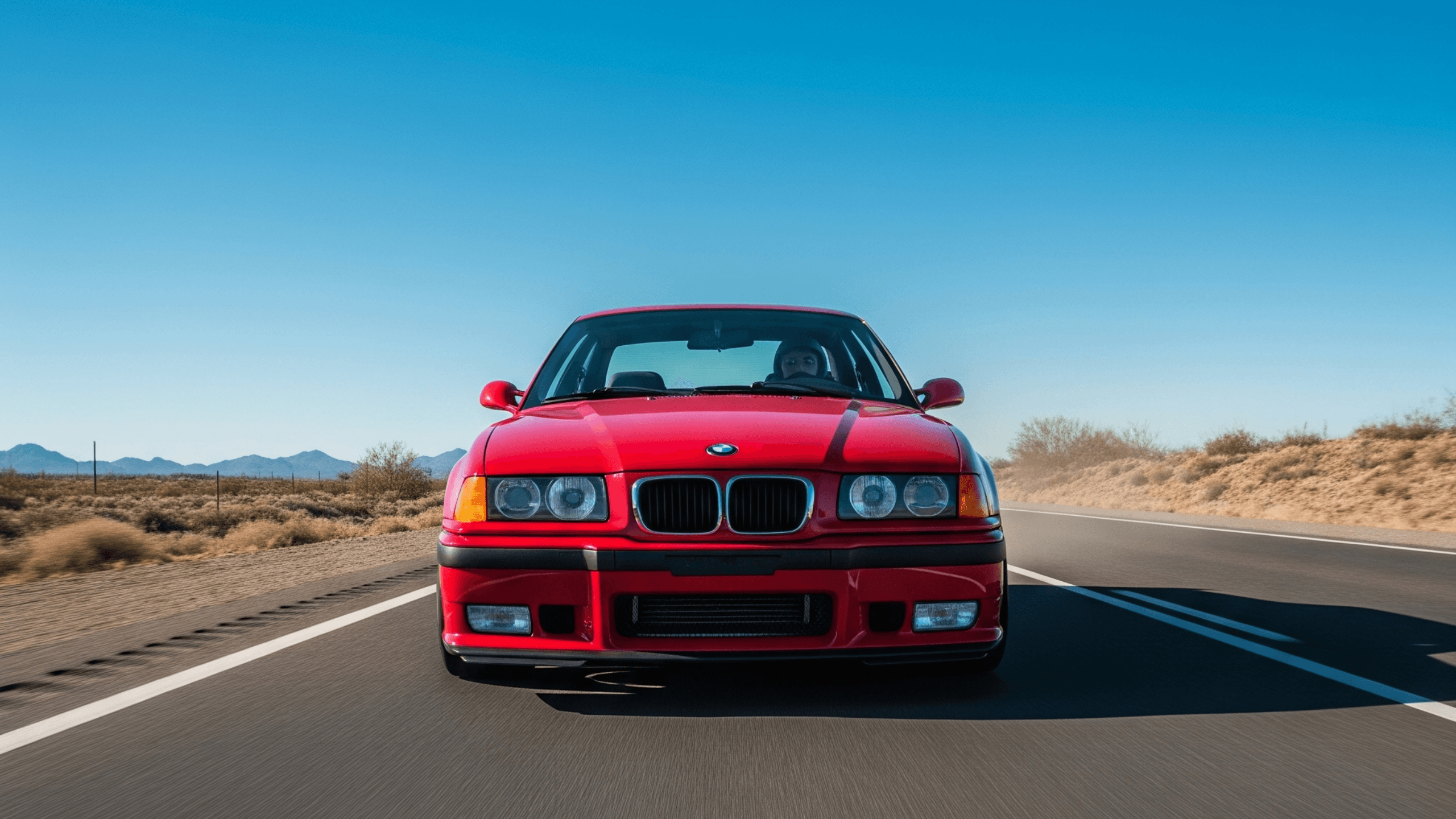 BMW E36 M3 driving on open road – ultimate buyer's guide to the legendary 1990s inline-six performance icon