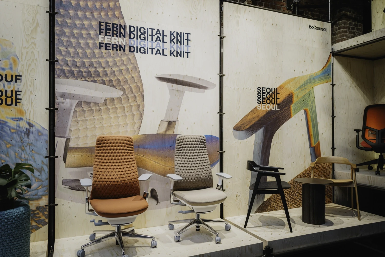 Fern Digital Knit office chairs in terracotta and beige in front of large fabric print panels.