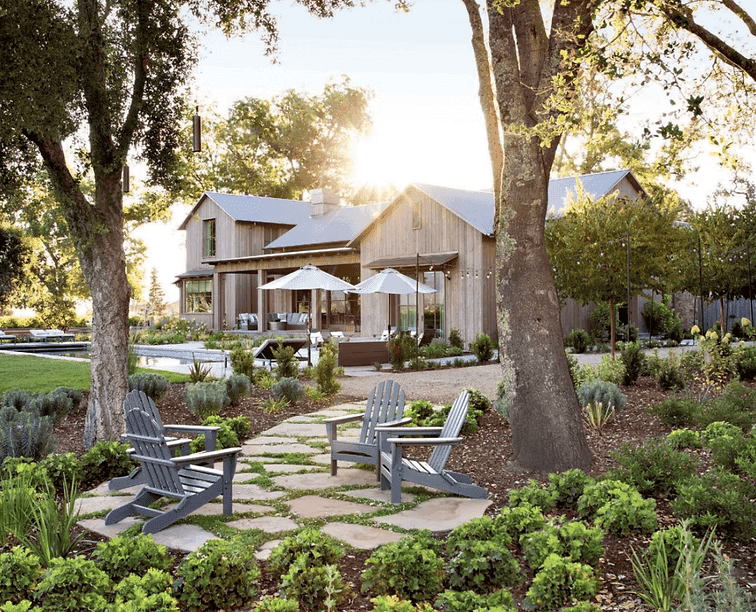 A person with short blonde hair holds a vintage camera.