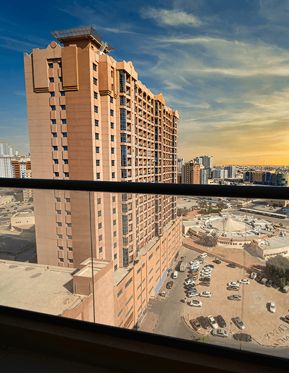 High-angle city view from an Al Nuaimia 1 balcony overlooking the Ajman skyline.