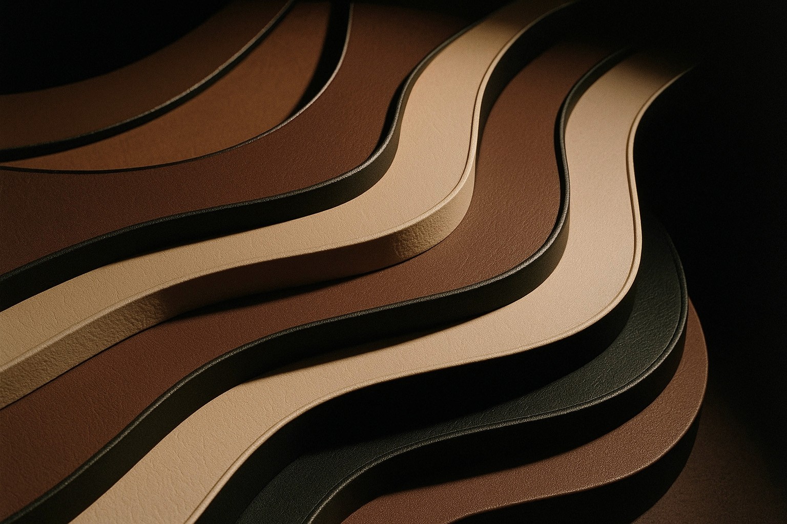 Artistic arrangement of curved leather strips in earthy tones—black, brown, and beige—stacked in a fluid wave pattern.