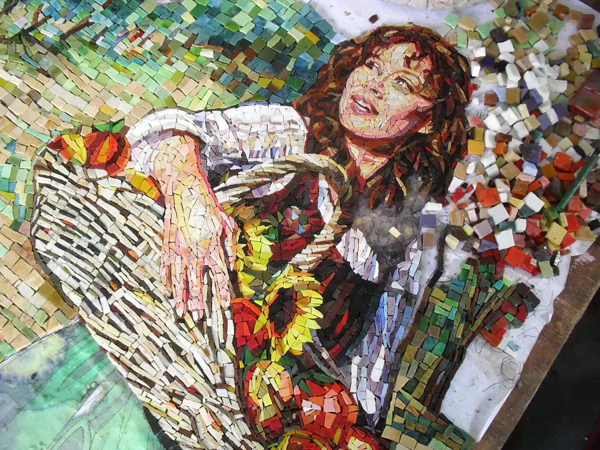 Mosaic backsplash mural featuring a woman in a garden, inspired by "A Walk in the Orchard" theme.