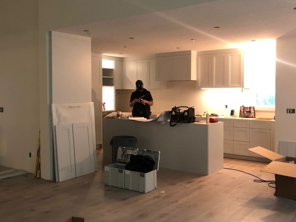 Image of KHD Homes construction team working on kitchen layout design and renovations with modern cabinetry installation.