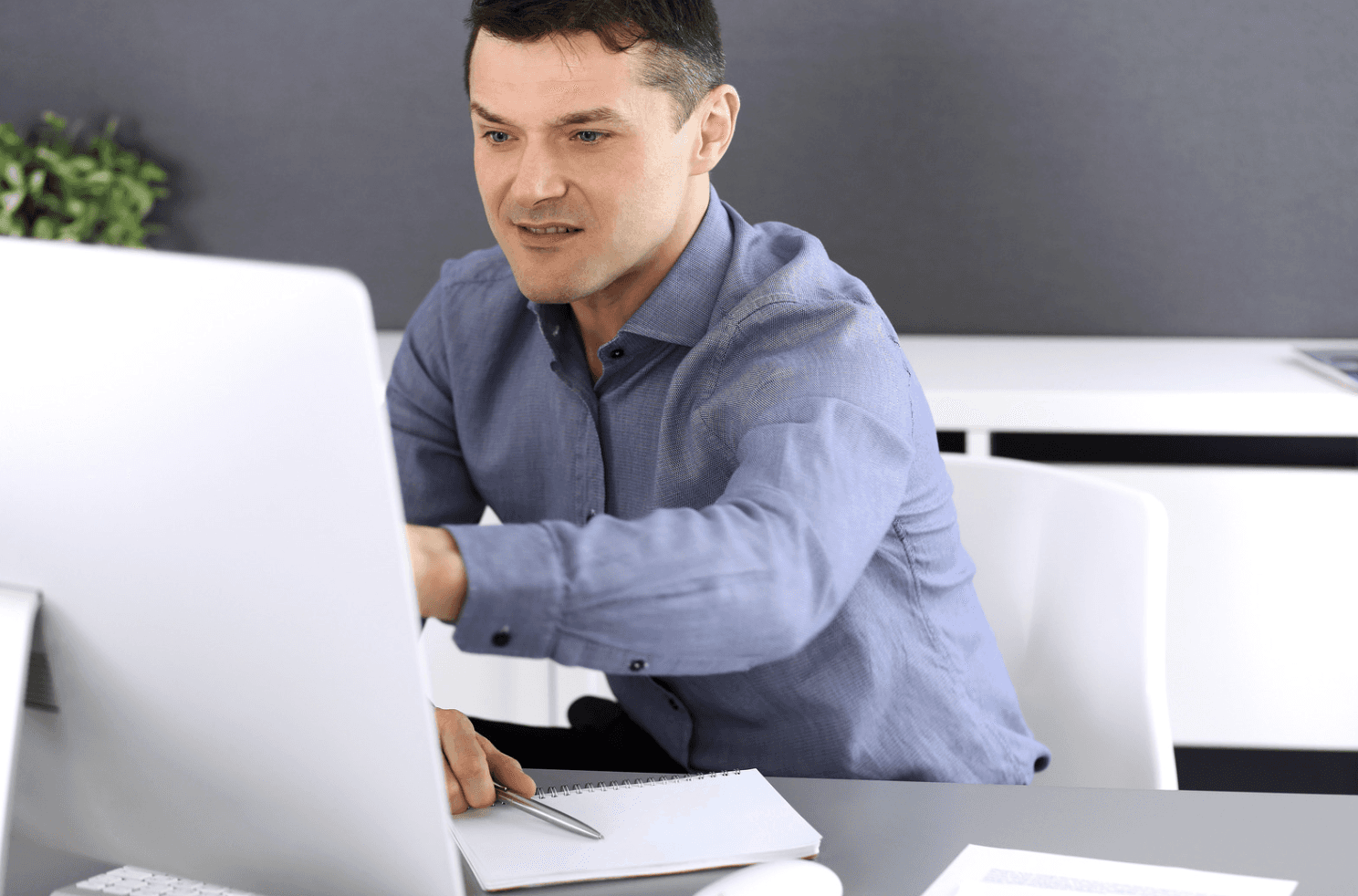 Man working on a desktop computer analyzing data, representing focused strategy and performance-driven Amazon PPC optimization.