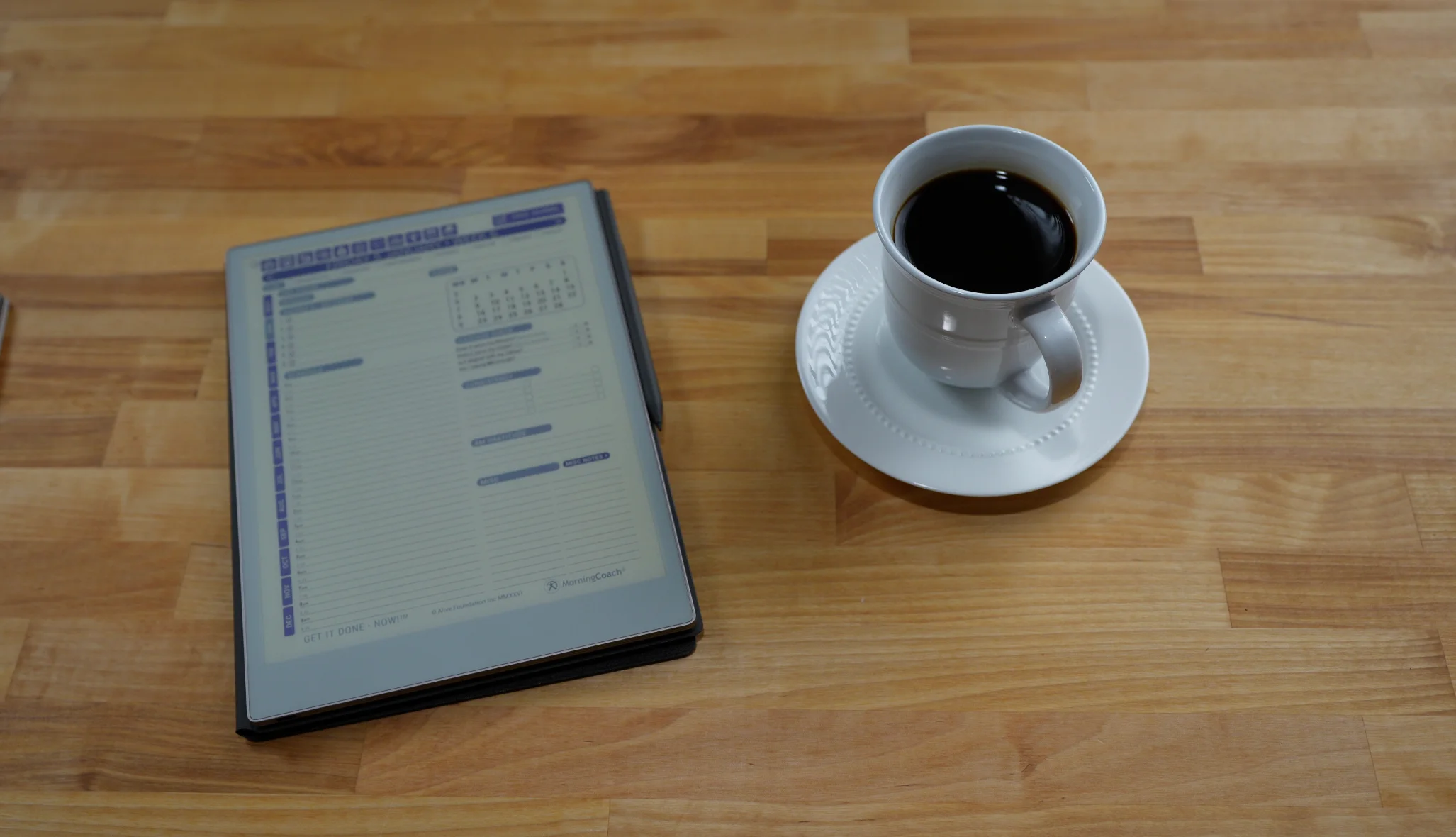 Get It Done — NOW! for reMarkable planner beside a coffee cup