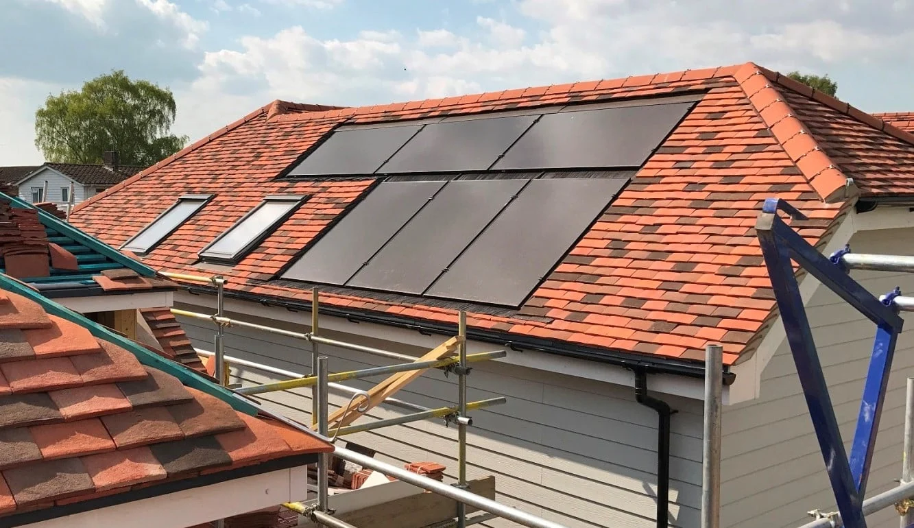 Installer placing a panel on a roof