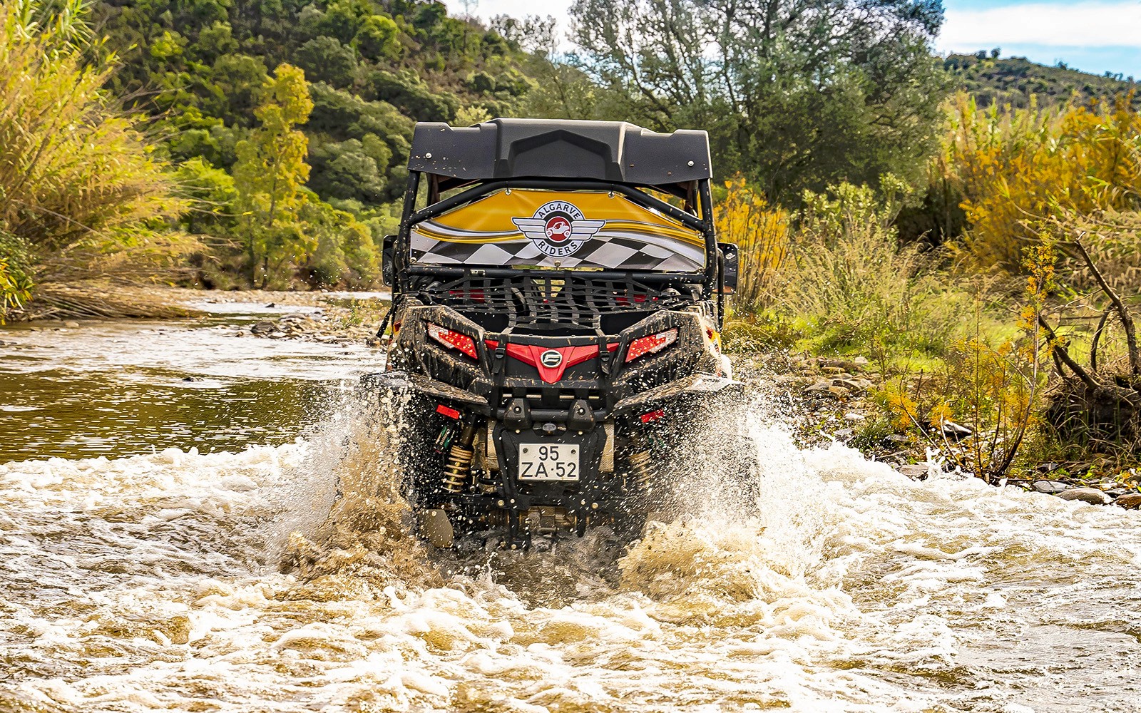 Buggy crossing a river in Algarve countryside during a tour.
