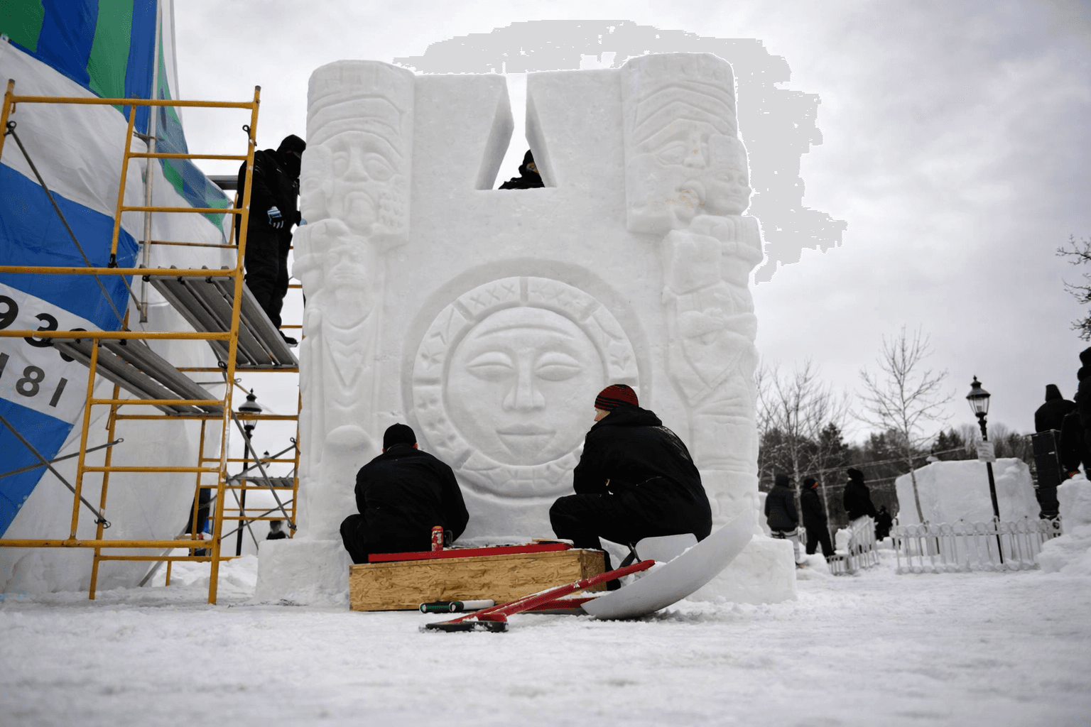 Ice sculptors working on a large snow and ice sculpture during the Breckenridge International Snow Sculpture Championships in winter