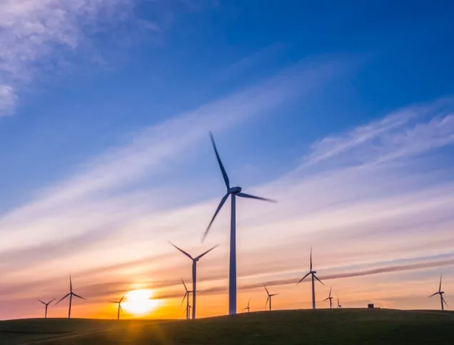 Wind turbines against a warm sky environment
