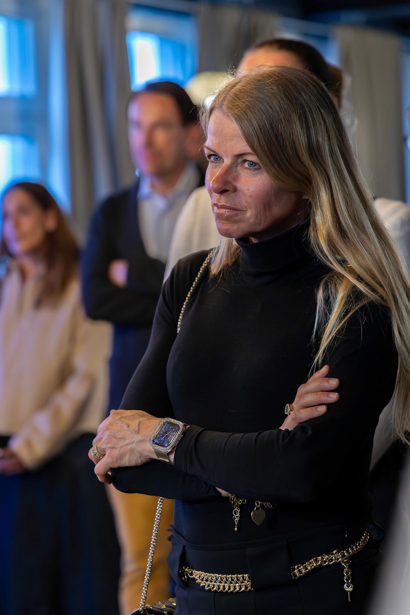 Woman listening attentively during a panel session.