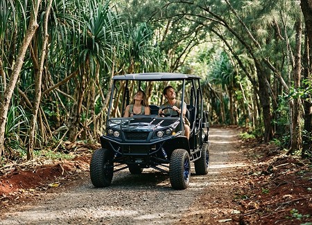 Rugged UTV path with UTV driving toward camera