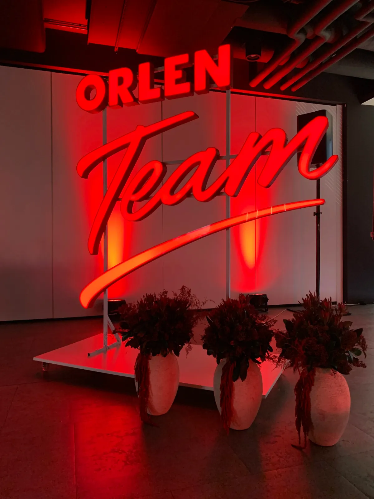 ORLEN Team press conference, ORLEN Team neon sign on stage
