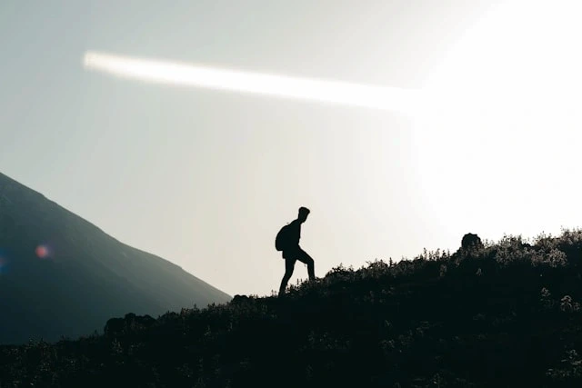 Person running outdoors at dawn with a weekly workout score card above the landscape