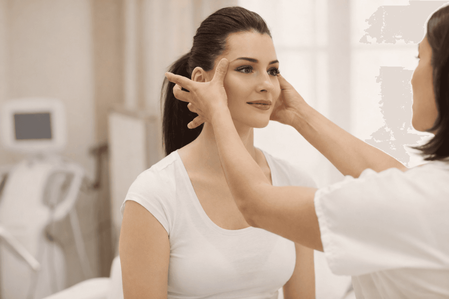 A woman receives a relaxing energy healing in a serene setting with soft lighting.