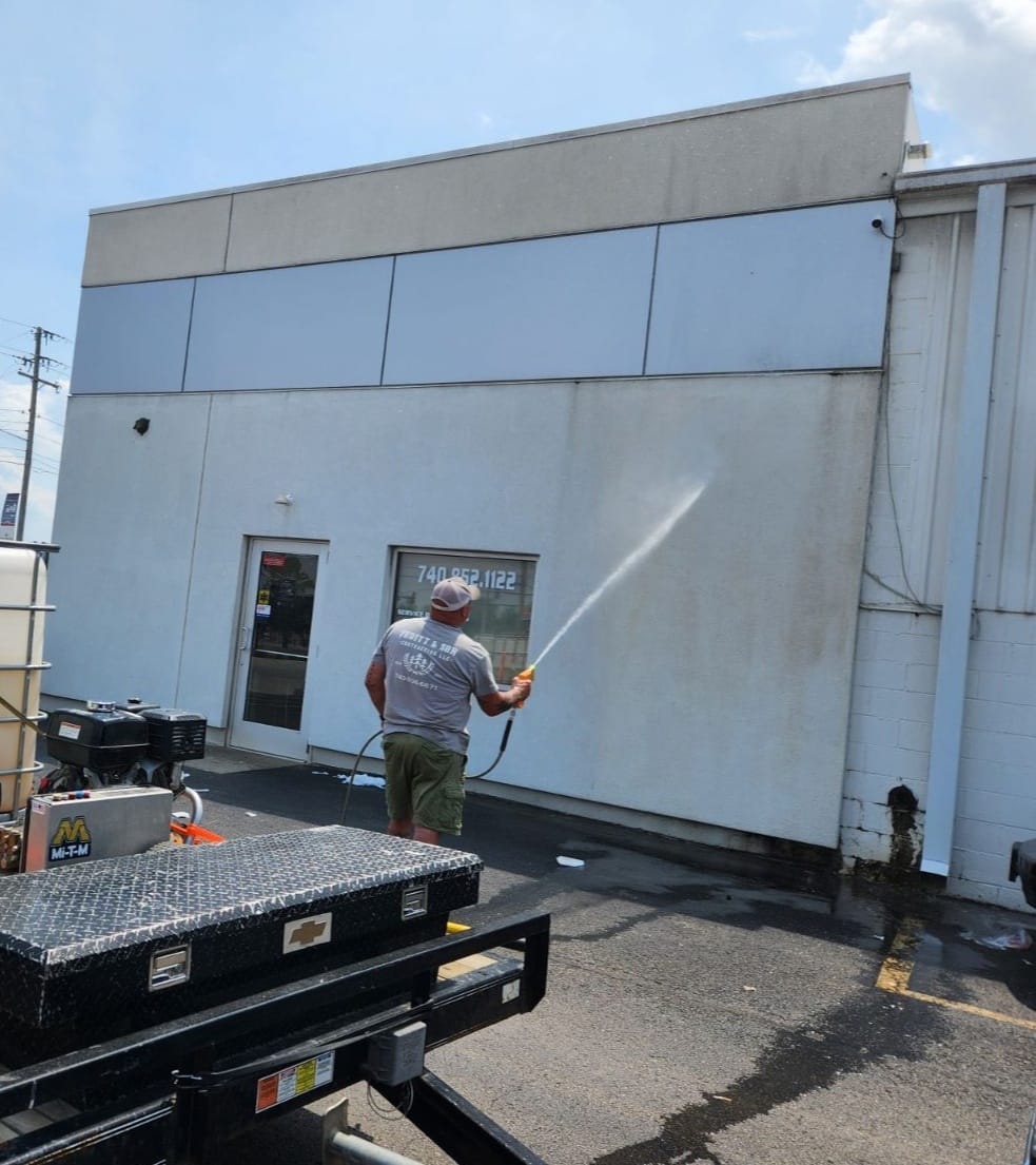 Modern bathroom featuring a walk-in shower, wooden vanity, round mirror, and elegant marble tiles.
