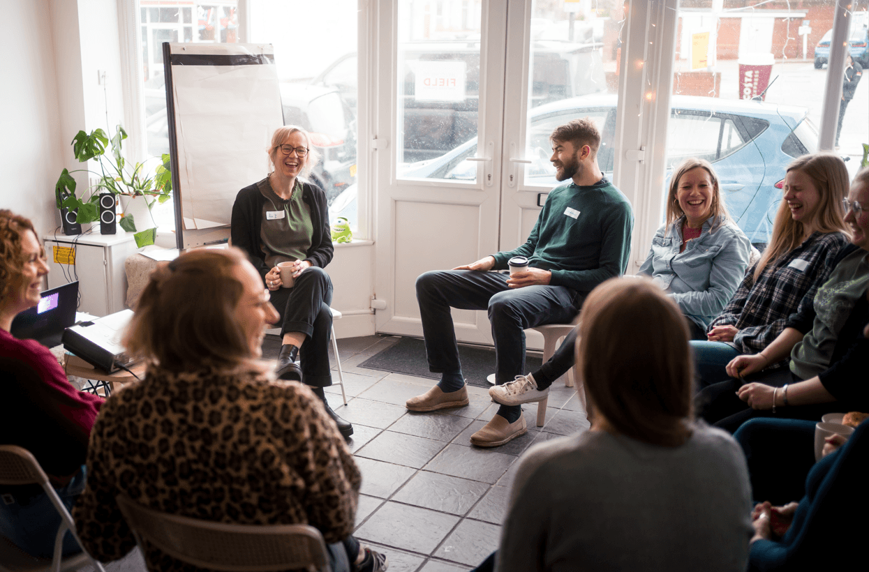 People sitting in a room talking and having fun.