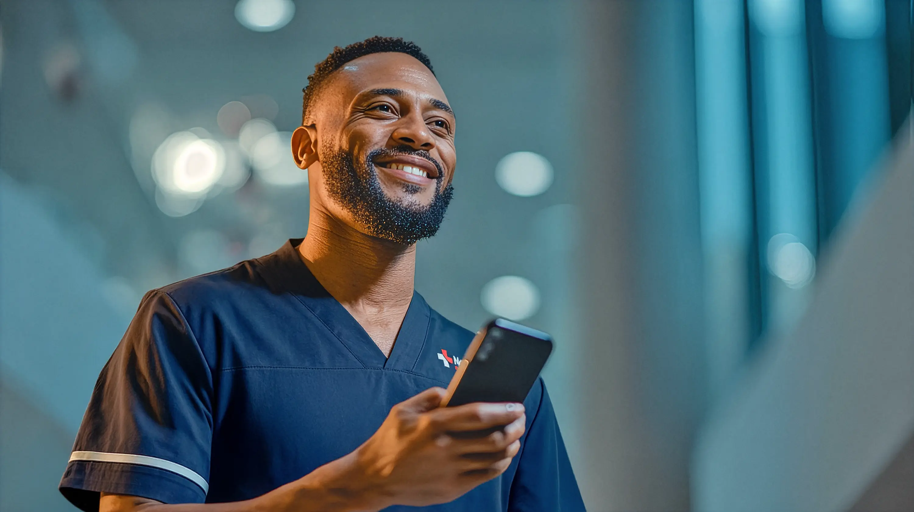 A newcross healthcare worker smiling with a phone