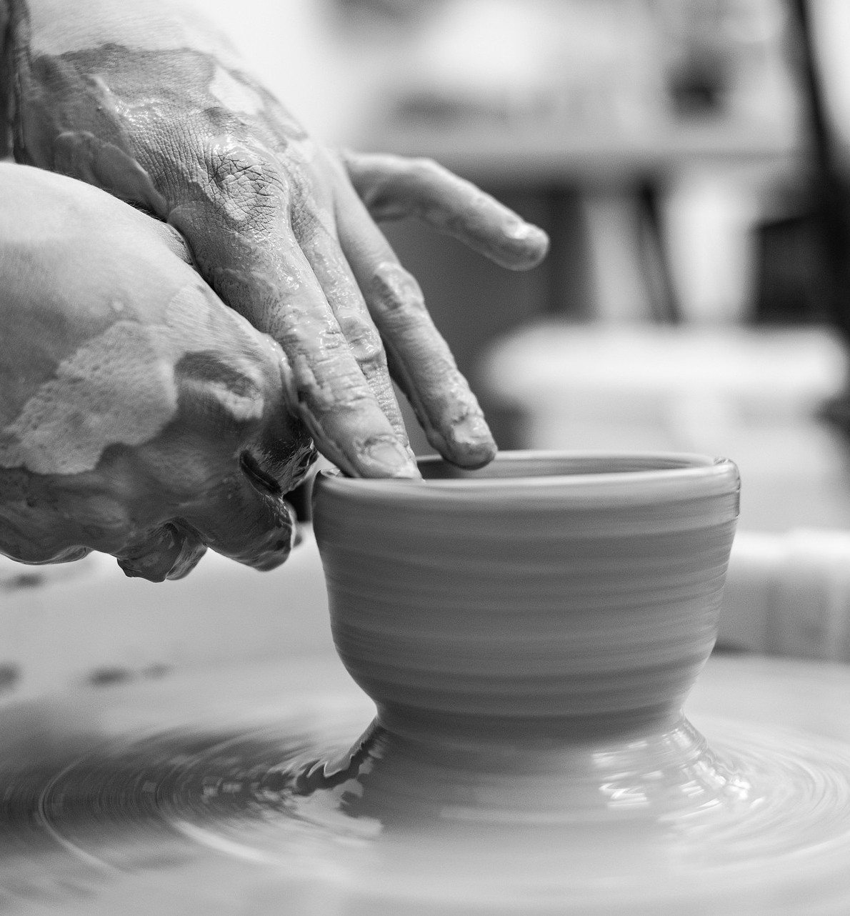 A stylish woman wearing a white hoodie and black glasses
