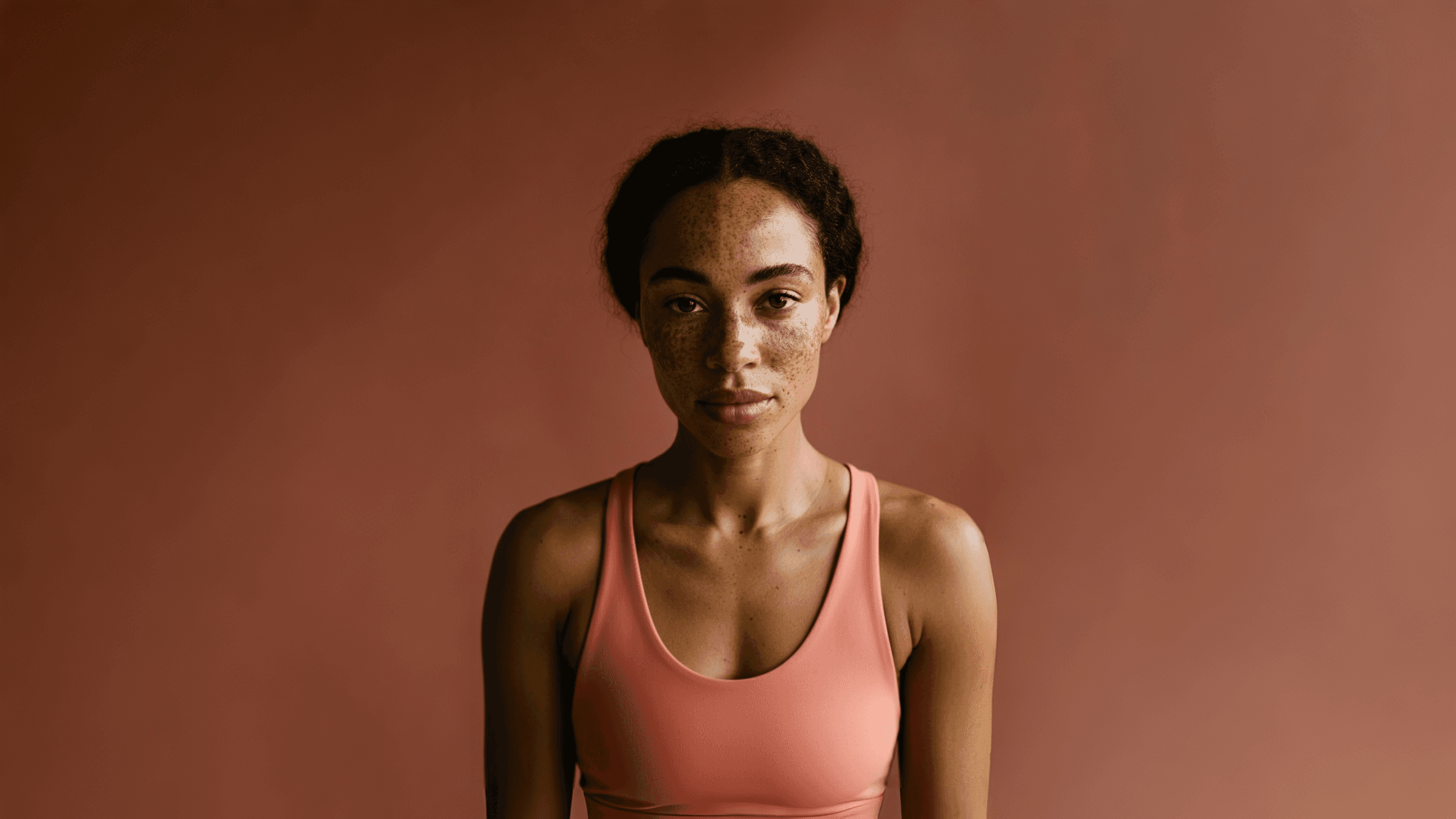 Portrait shot of a woman in a yoga outfit.