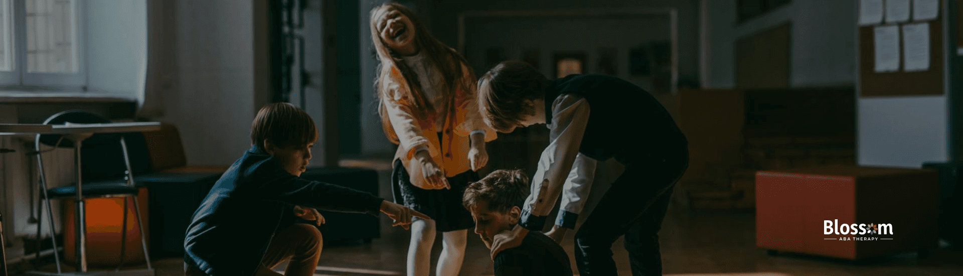 Group of children points and laughs at an autistic boy sitting on the floor of a school in Virginia.