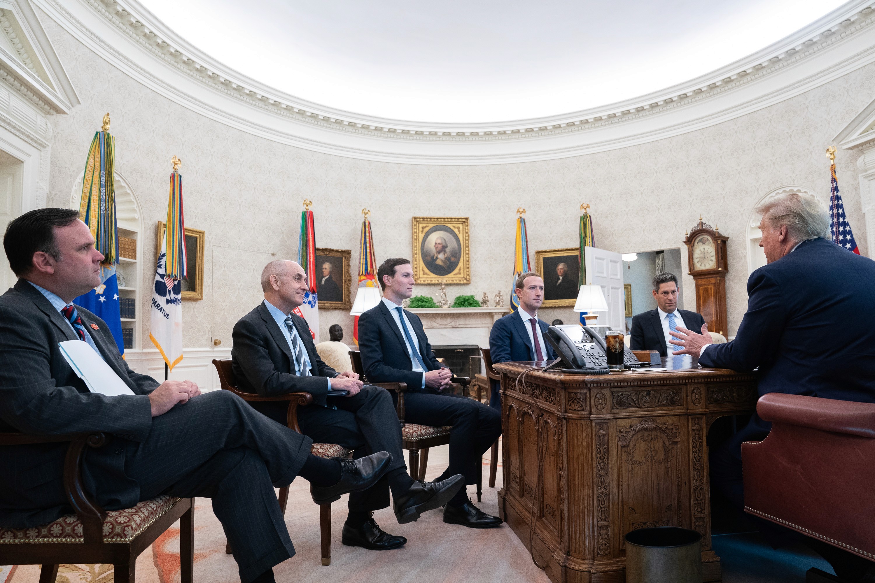 A meeting between public officials and technology executives in the Oval Office
