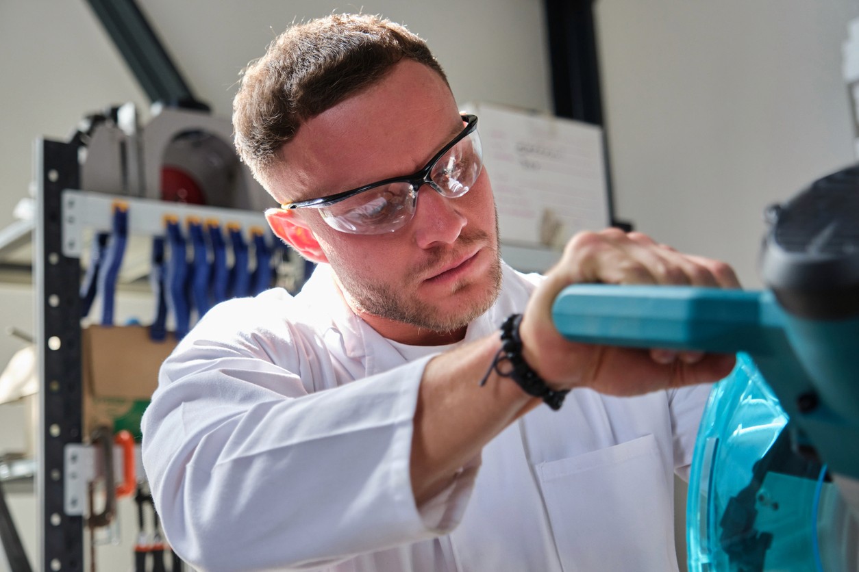 Silhouette of a person in profile set against a textured gradient background transitioning from green to orange.