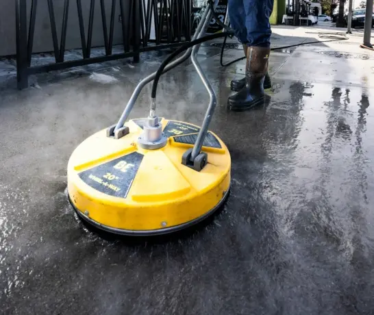 a man in a yellow vest is cleaning the street