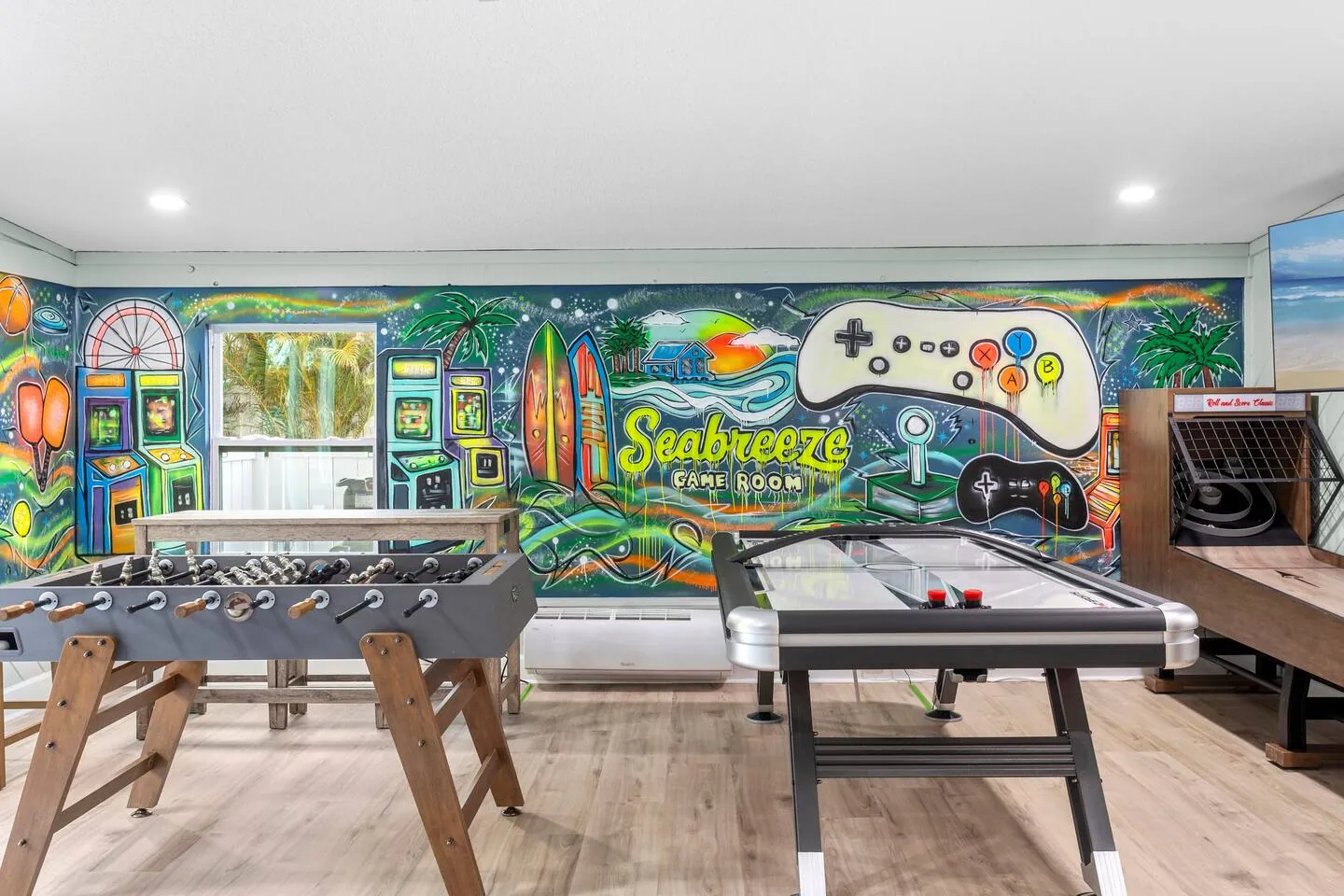 Game room with foosball, air hockey, skee-ball and mural reading “Seabreeze Game Room” at Private Backyard Resort, Bradenton, Florida