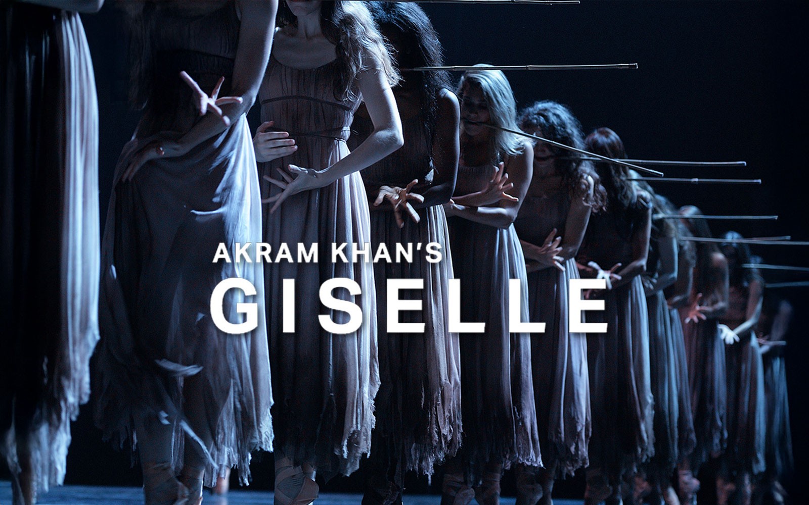 Dancers in Akram Khan's Giselle performing on stage in dim lighting.