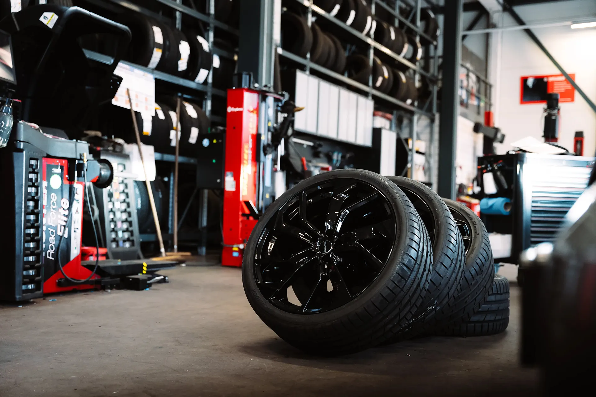 Inside the car dealership garage were wheels have been uninstalled from the car