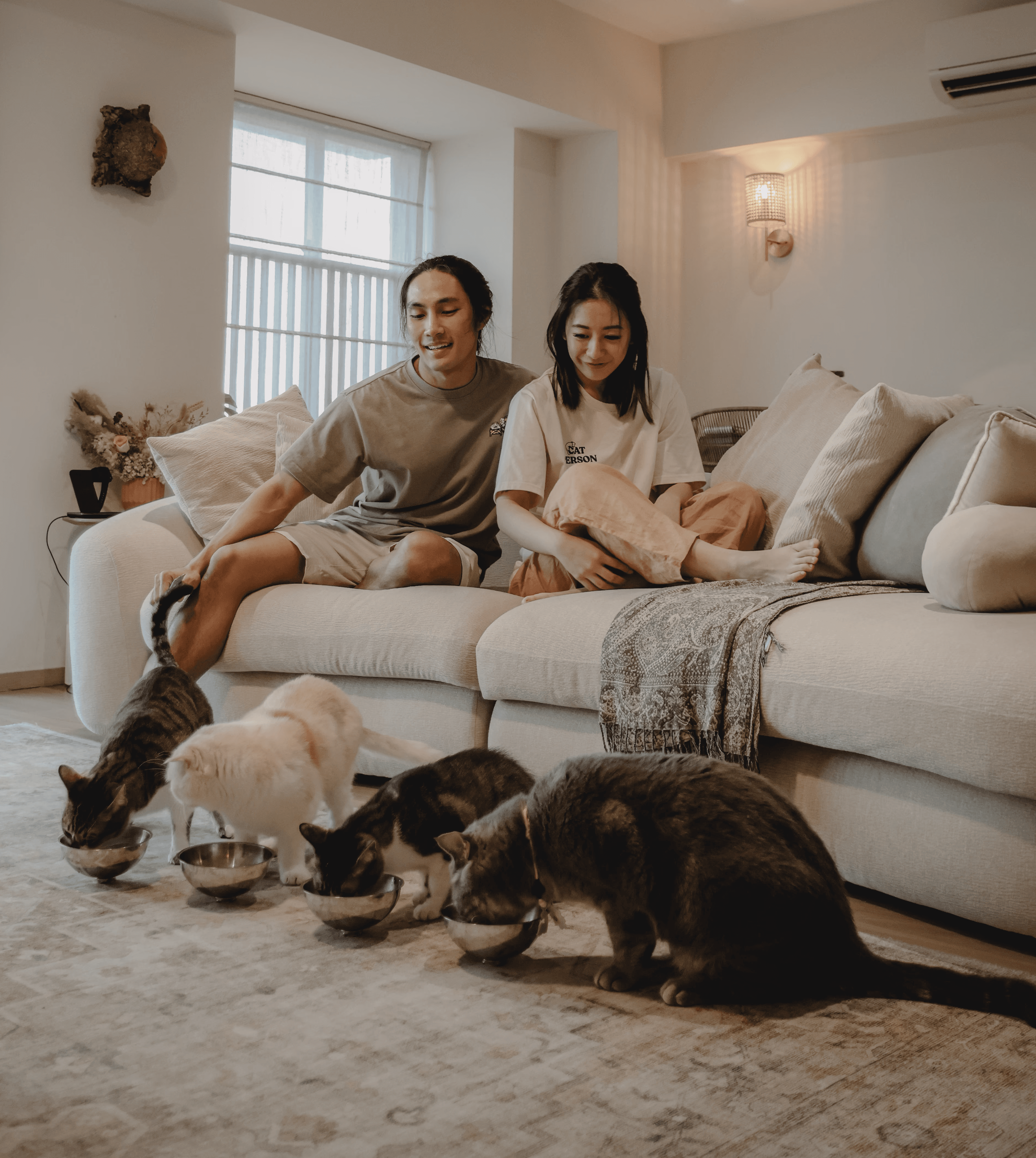 A young person with long, wavy hair sits in front of a plain background, looking directly at the camera.