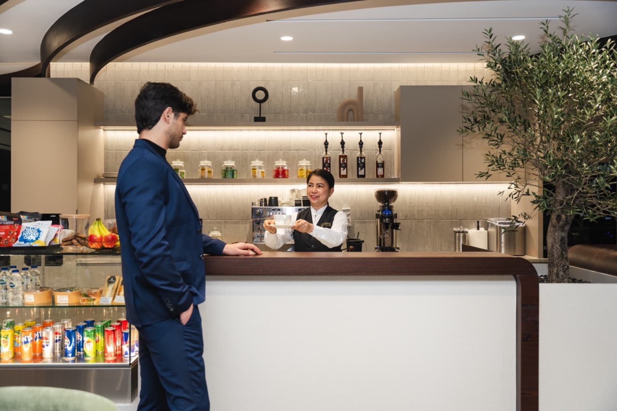 Office Square's café inside our meeting rooms in Dubai, offering a comfortable setting with lounge seating and self-service facilities.