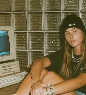 Two hands in an elegant gesture, one above the other, against a dark background