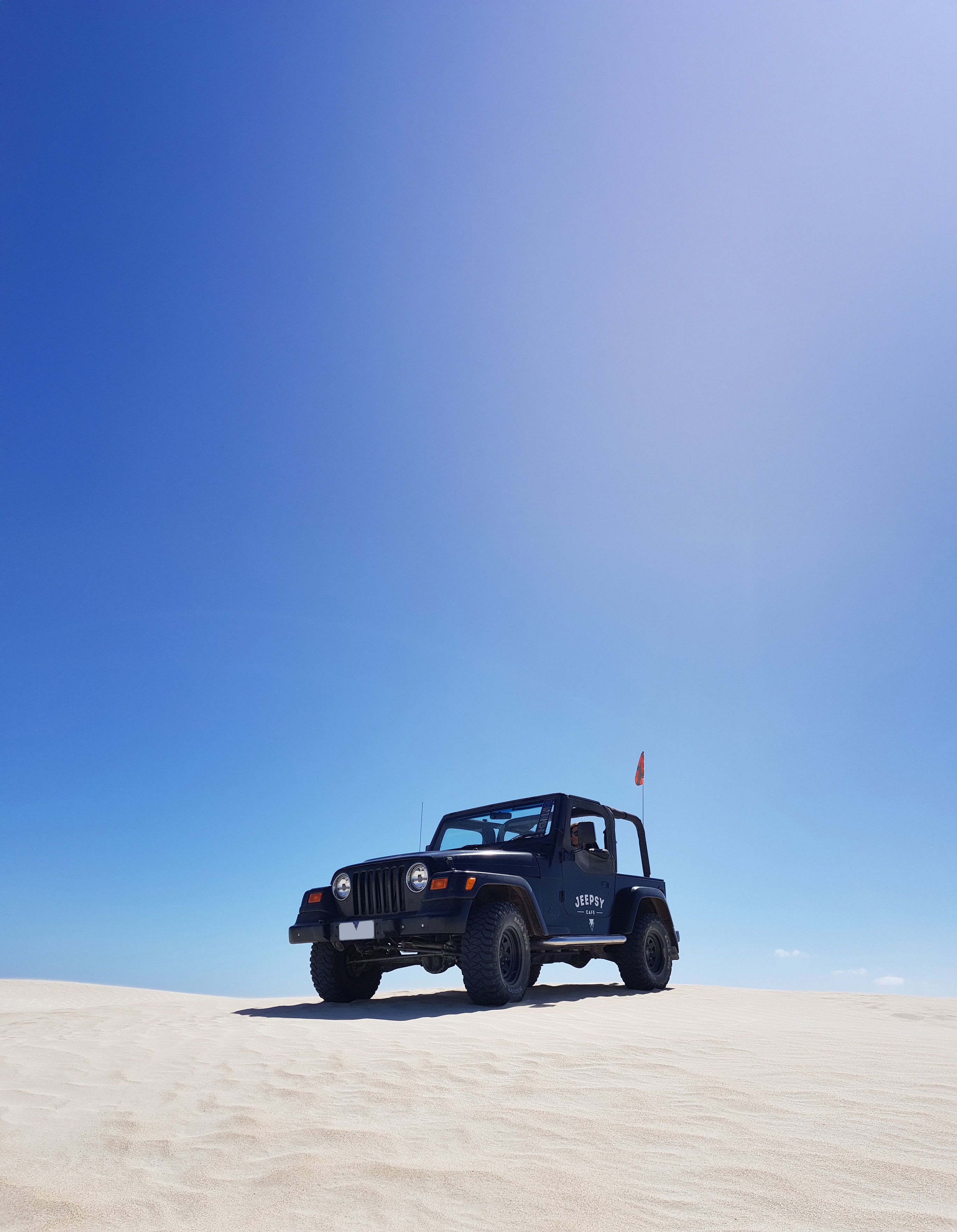 Dynamic picture of Jeep Wrangler on sand dunes