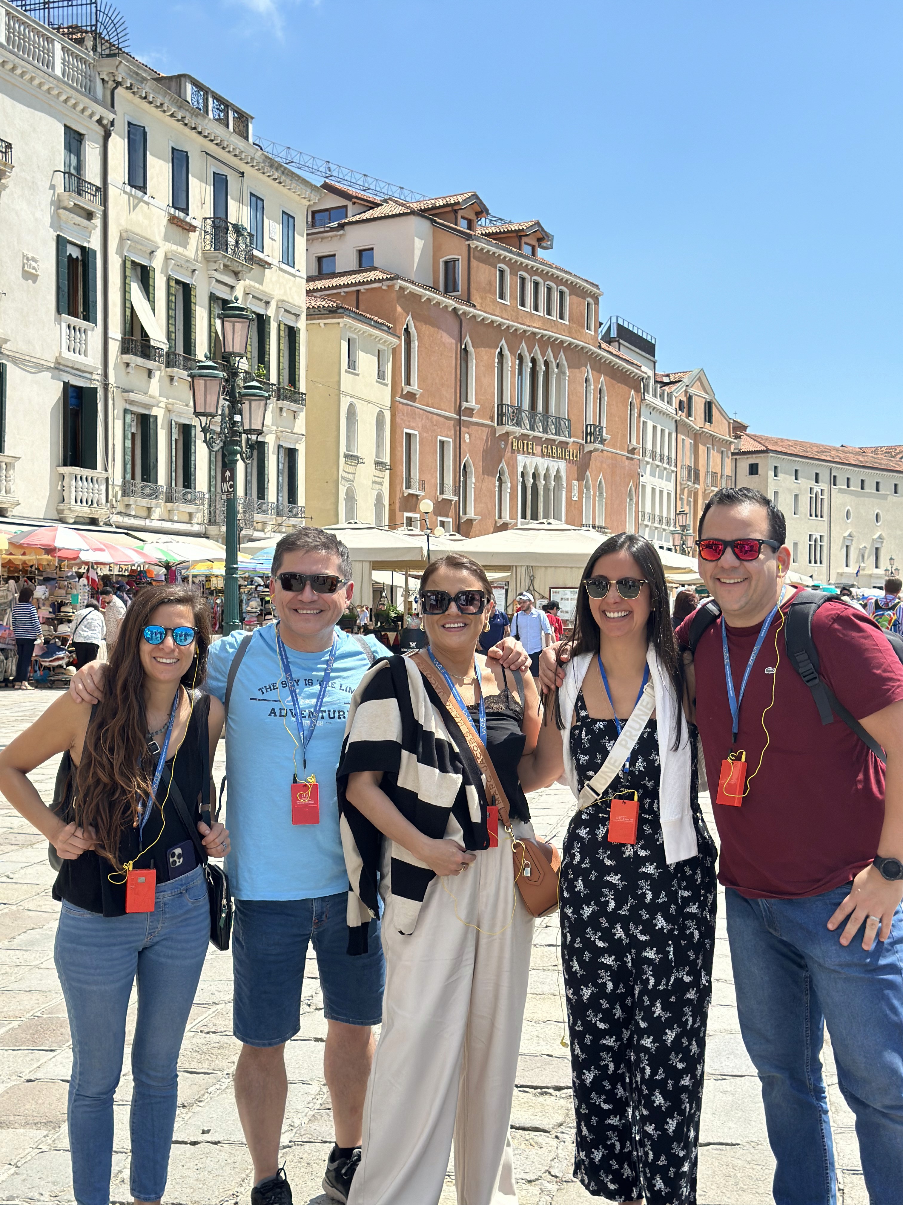 three people sitting in front of table laughing together