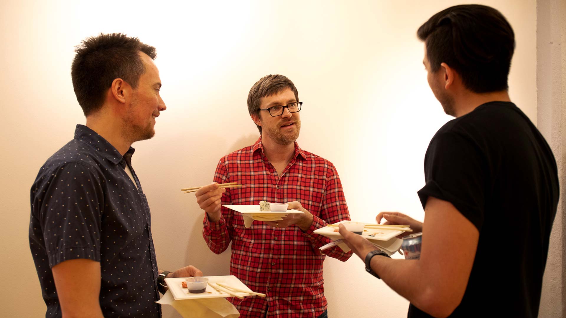 Three sva faculties eating sushi and talking